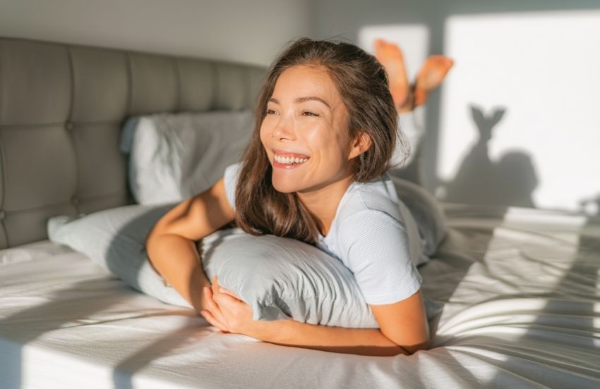 Woman in the morning sun on mattress